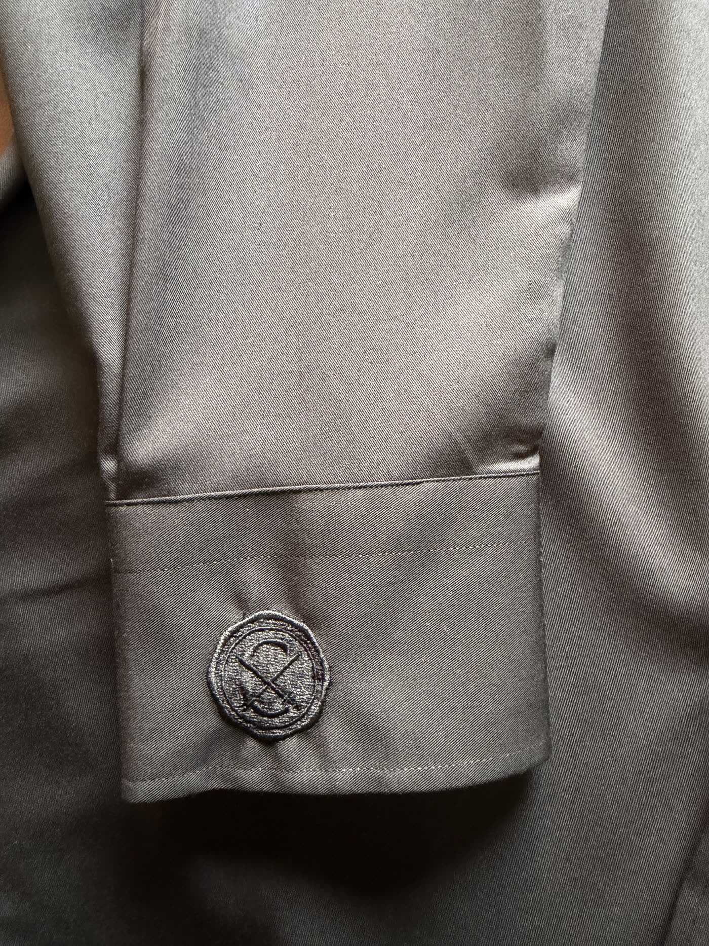 A monogram embroidered on the cuff of a Conxeppt custom shirt
